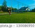 The child goes in for sports at the stadium. The boy training before playing football. 130086950
