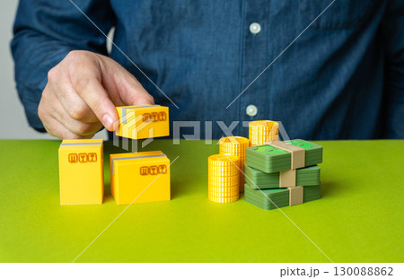 A man collects goods comparable in value to a stack of money. Balance of trade. Trade and commerce. Exchange, market value, import export 130088862