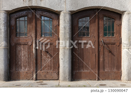 Two rustic wooden double doors with weathered textures Two rustic wooden double doors with weathered textures 130090047