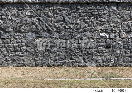 A rustic stone brick wall, background photo texture 130090072