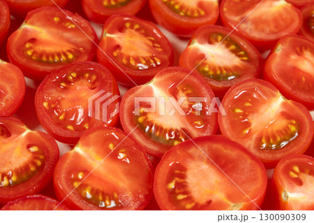 Close-Up of Fresh Cut Small Tomatoes. Vibrant Red Culinary Background. 130090309