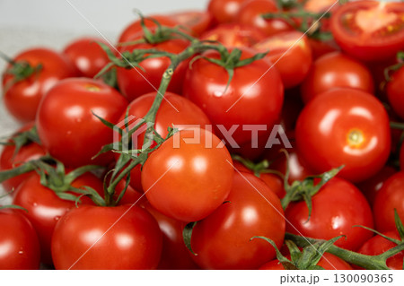 Lots of ripe fresh cocktail tomatoes close-up. 130090365