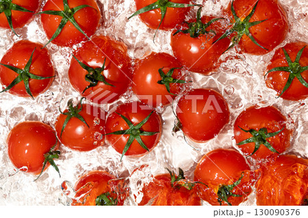 Water Burst Around Fresh Tomatoes Overhead Angle 130090376