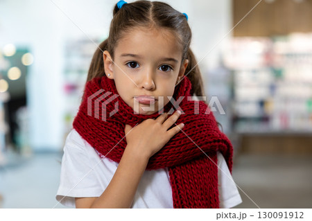 Cute girl with a red scarf looking upset and sad 130091912