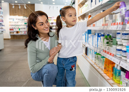 Mom and daughter in the pharmacy choosing medicines Mom and daughter in the pharmacy choosing medicines 130091926