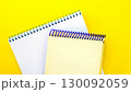 White and beige notepads on a yellow background. 130092059