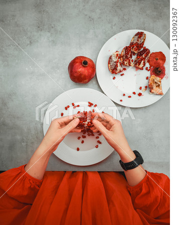 Woman opening pomegranate fruit on rosh hashanah jewish new year celebration 130092367