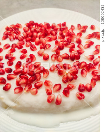 Delicious white cake decorated with fresh pomegranate seeds for birthday 130092453