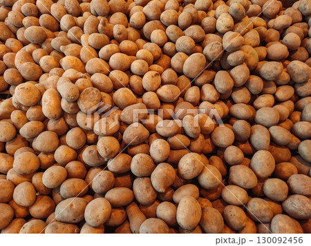Fresh potatoes forming a textured background at the market Fresh potatoes forming a textured background at the market 130092456
