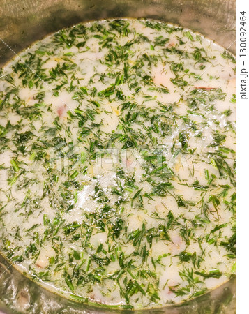 Creamy dill soup simmering in metal pot, comfort food close up Mushroom soup 130092464