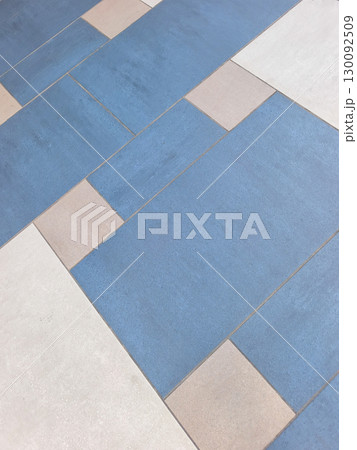 Geometric pattern of blue and white tiles creating visual interest on a floor Geometric pattern of blue and white tiles creating visual interest on a floor 130092509