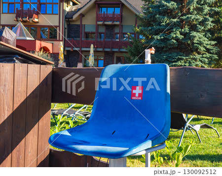 Blue rescue chair standing by a wooden fence in besenova, slovakia Blue rescue chair standing by a wooden fence in besenova, slovakia 130092512