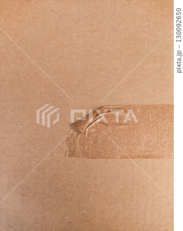 Brown packaging tape peeling from cardboard box in prague Brown packaging tape peeling from cardboard box in prague 130092650