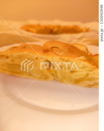Delicious homemade apple pie showing soft texture and golden crust 130092696