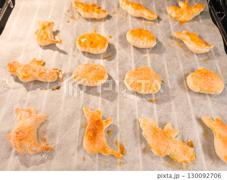 Halloween puff pastry cookies baking on oven tray 130092706