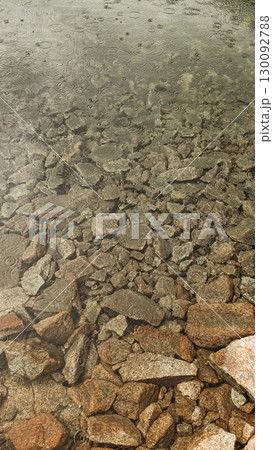 Rain falling on rocky lake shore in high tatras mountains, slovakia Rain falling on rocky lake shore in high tatras mountains, slovakia 130092788
