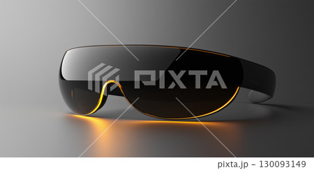 Futuristic eclipse glasses glowing orange, resting on sleek gray surface, waiting for upcoming celestial spectacle 130093149