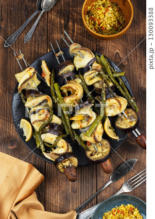 Delicious food on skewers, fish kebabs. Delicious food on skewers, fish kebabs. 130093388