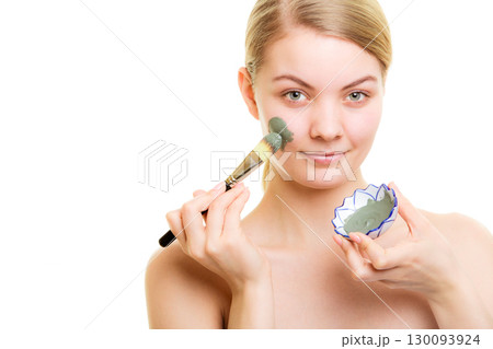 Skin care. Woman applying clay mud mask on face. Skin care. Woman applying clay mud mask on face. 130093924