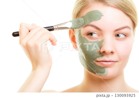 Skin care. Woman applying clay mud mask on face. Skin care. Woman applying clay mud mask on face. 130093925