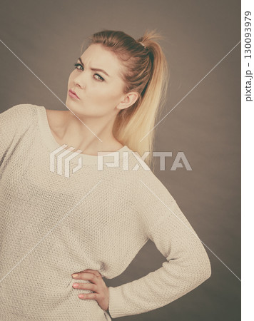 Confused young blonde woman looking suspicious Confused young blonde woman looking suspicious 130093979