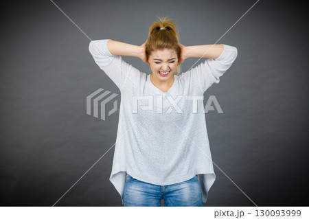 Unhappy woman screaming and yelling in pain 130093999