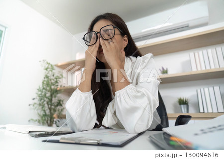 Stress Management. Woman rubbing her eyes in frustration at her desk. Stress Management. Woman rubbing her eyes in frustration at her desk. 130094616