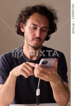man using otg usb with her mobile phone to copy photos man using otg usb with her mobile phone to copy photos 130095385