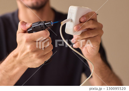 Engaging in the hands on repairing of electric devices using precision tools for effective results 130095520