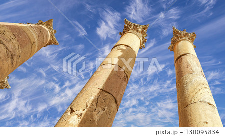 Roman Columns in the Jordanian city of Jerash (Gerasa of Antiquity), capital and largest city of Jerash Governorate, Jordan. Against the background of a beautiful sky with clouds 130095834