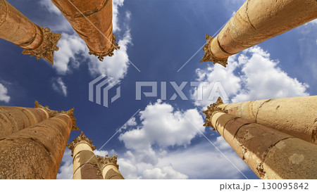 Roman Columns in the Jordanian city of Jerash (Gerasa of Antiquity), capital and largest city of Jerash Governorate, Jordan. Against the background of a beautiful sky with clouds 130095842