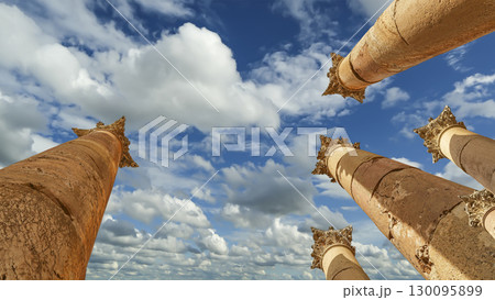 Roman Columns in the Jordanian city of Jerash (Gerasa of Antiquity), capital and largest city of Jerash Governorate, Jordan. Against the background of a beautiful sky with clouds 130095899