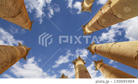 Roman Columns in the Jordanian city of Jerash (Gerasa of Antiquity), capital and largest city of Jerash Governorate, Jordan. Against the background of a beautiful sky with clouds 130095904