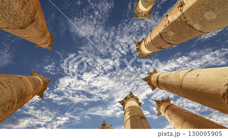 Roman Columns in the Jordanian city of Jerash (Gerasa of Antiquity), capital and largest city of Jerash Governorate, Jordan. Against the background of a beautiful sky with clouds 130095905