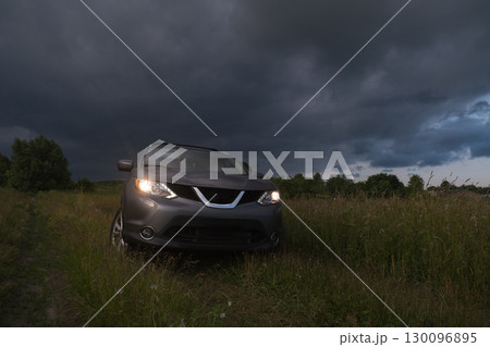 SUV in a Field Under Dramatic Skies SUV in a Field Under Dramatic Skies 130096895