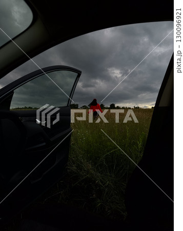 Person in Red Jacket Standing in Field 130096921