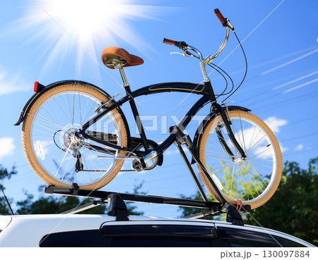 Bike transportation - bike on the roof of a car Bike transportation - bike on the roof of a car 130097884