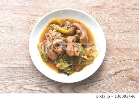 boiled braised salty pork leg and slice pickled cabbage in Chinese herb brown soup on plate 130098446