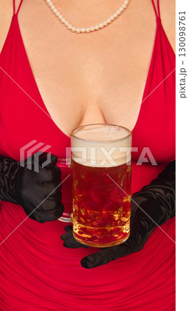 Close up of elegant woman in red dress holding beer mug with black gloves 130098761