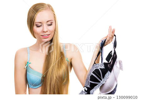 Girl holding bras in hand Girl holding bras in hand 130099010