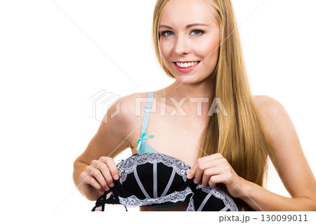 Woman trying on black bra with lace 130099011