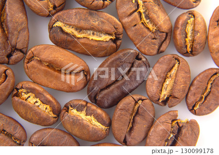 Vibrant macro image of roasted coffee beans, revealing their intricate textures 130099178