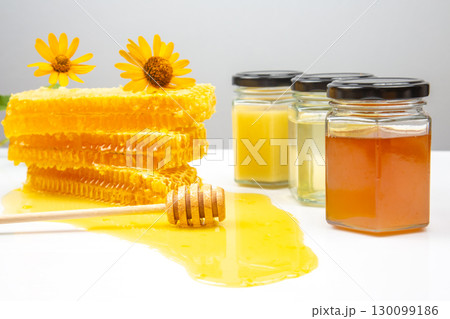 Fresh flower honey in a wooden bowl, spoon, pollen and honeycomb. vitamin food for health and life Fresh flower honey in a wooden bowl, spoon, pollen and honeycomb. vitamin food for health and life 130099186