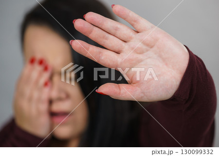 Scared woman with stop hand gesture Scared woman with stop hand gesture 130099332