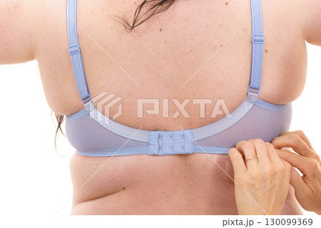Bra fitter help plus size woman find perfect fit. Back view. 130099369