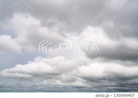Dramatic overcast sky with gray and white clouds before rainy season storm, moody and gloomy weather background. Climate, meteorology, and atmospheric. Weather forecasting, climate change background. 130099407