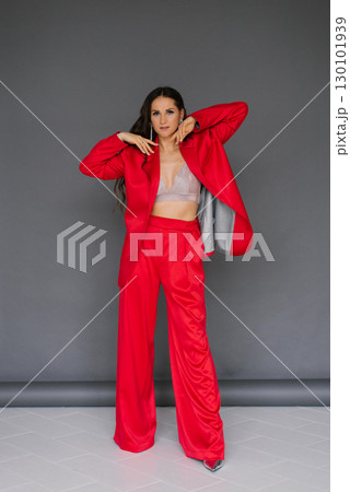 Young woman in red outfit poses for the camera 130101939