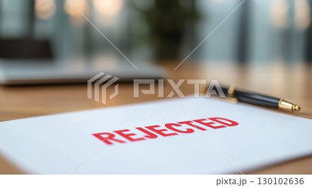 business document with prominent red REJECTED mark, symbolizing disappointment and rejection in professional setting 130102636