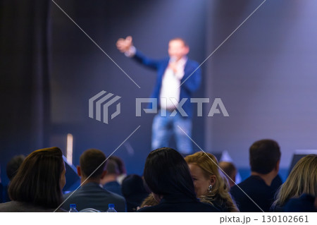 Speaker addressing audience during a business conference in an auditorium 130102661