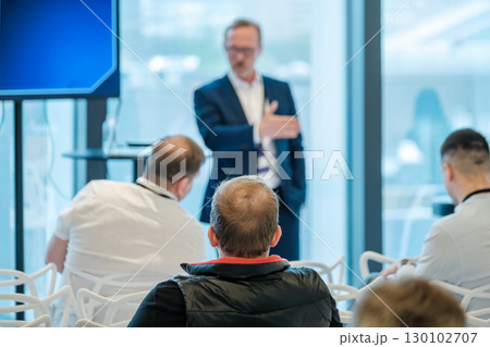 Speaker presenting at business meeting with audience in modern conference room Speaker presenting at business meeting with audience in modern conference room 130102707